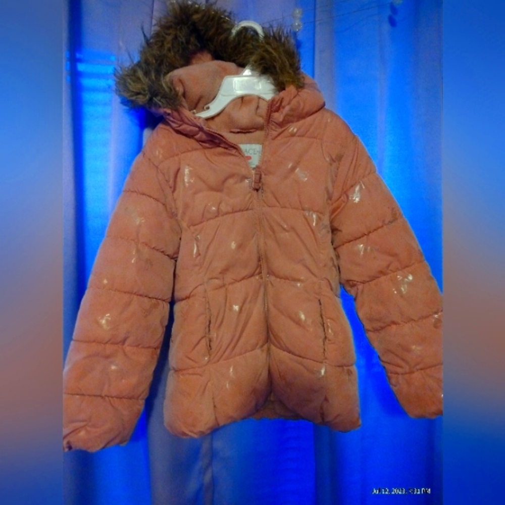 Pink winter coat with iridescent unicorn's on it